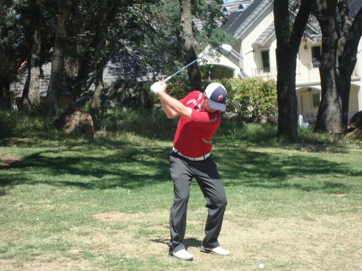 Golfer swinging club