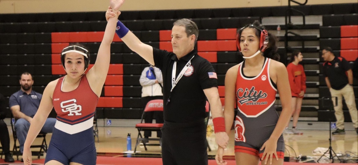 Referee raises Emily Lau's arm in victory